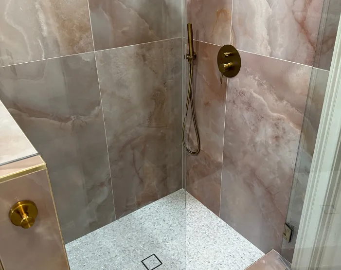 custom tile shower with gold hardware